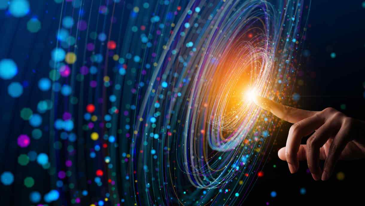Hand reaching towards a glowing digital swirl